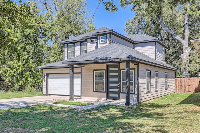 view of front of property featuring a front yard and a garage