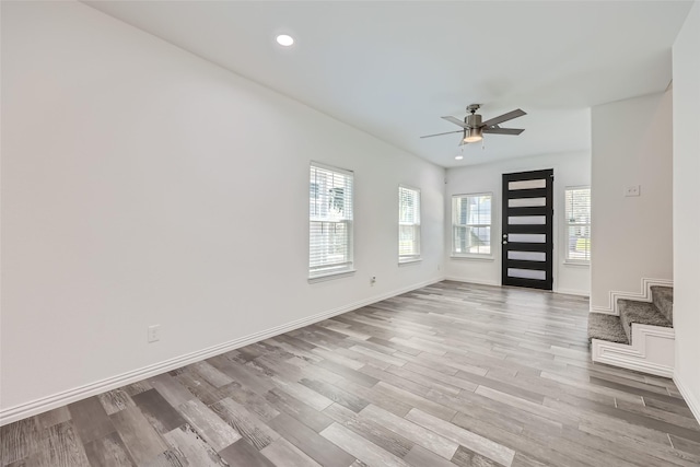 interior space with ceiling fan and light hardwood / wood-style floors