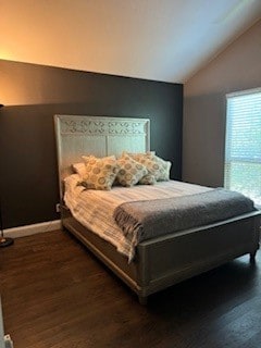 bedroom featuring lofted ceiling and dark hardwood / wood-style flooring