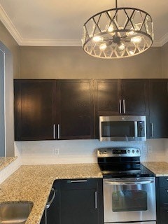 kitchen with crown molding, backsplash, light stone countertops, and appliances with stainless steel finishes