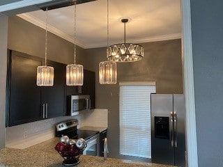 kitchen with crown molding and appliances with stainless steel finishes