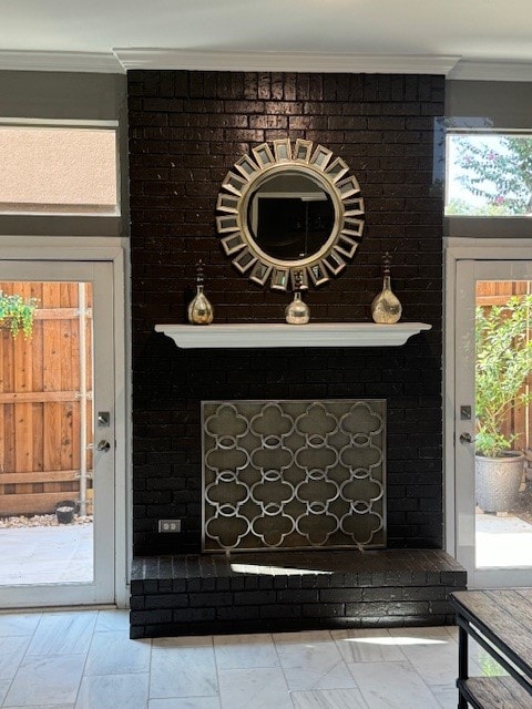 interior details with ornamental molding and a fireplace