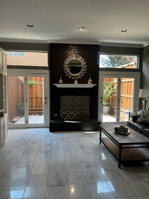 interior space featuring a wealth of natural light, ornamental molding, and a brick fireplace