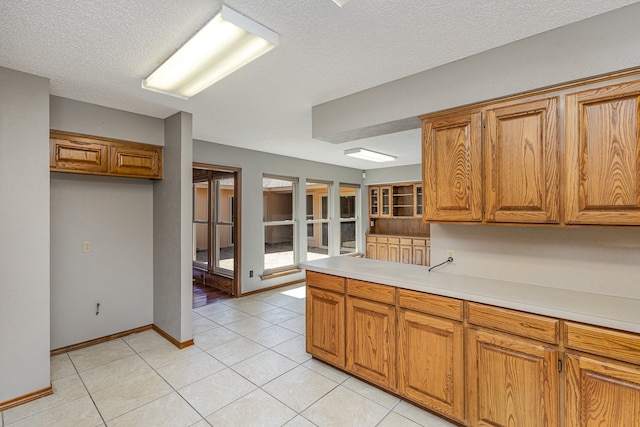 kitchen featuring light tile patterned floors and a textured ceiling