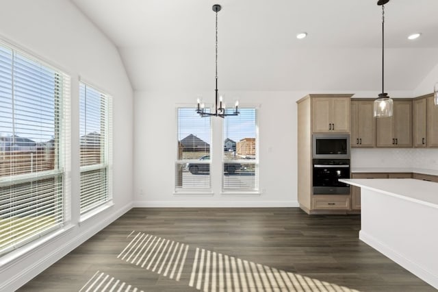 kitchen with an inviting chandelier, wall oven, lofted ceiling, built in microwave, and hanging light fixtures