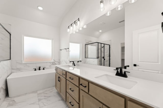 bathroom with vaulted ceiling, shower with separate bathtub, and vanity