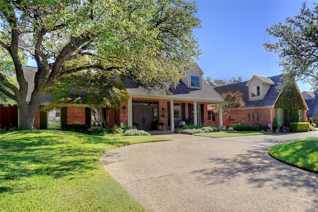 cape cod home with a front yard