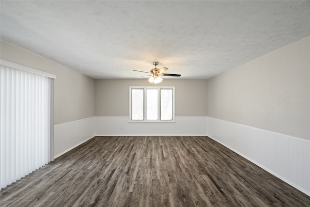 unfurnished room featuring a textured ceiling, dark wood-type flooring, and ceiling fan