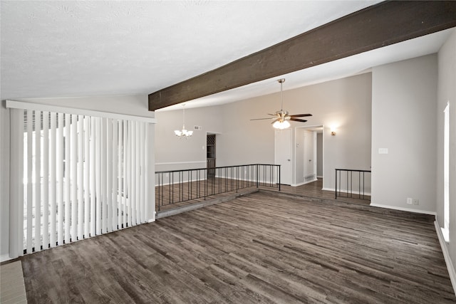 empty room featuring dark hardwood / wood-style floors, lofted ceiling with beams, a textured ceiling, and ceiling fan with notable chandelier