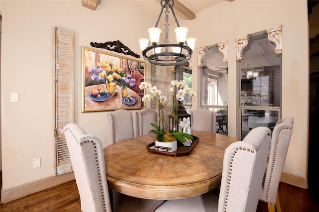 dining area with a notable chandelier and dark hardwood / wood-style flooring