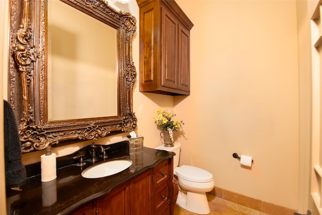 bathroom with tile patterned floors, vanity, and toilet