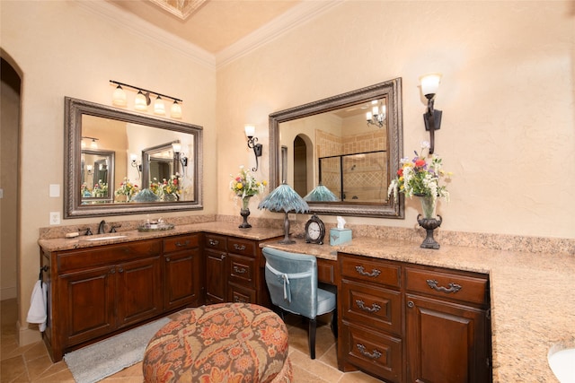 bathroom with crown molding, vanity, and a shower with shower door