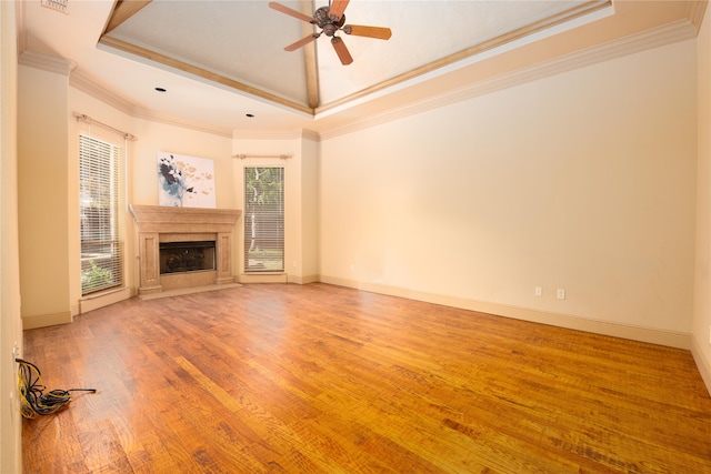 unfurnished living room featuring a wealth of natural light, hardwood / wood-style floors, and ornamental molding