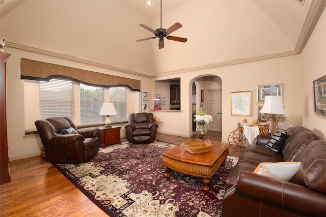 living room with hardwood / wood-style floors, high vaulted ceiling, and ceiling fan