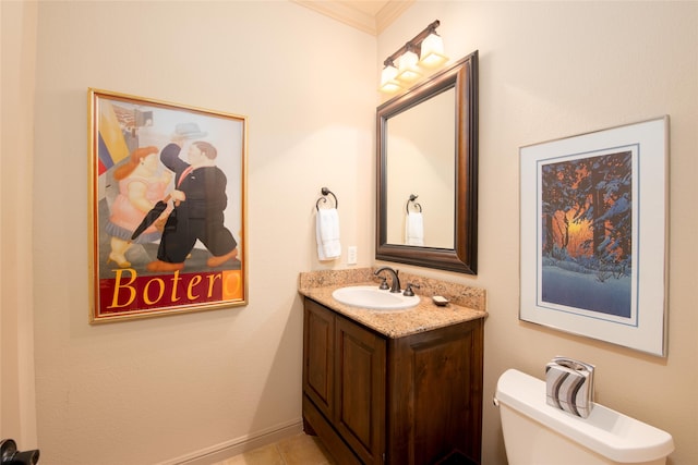 bathroom featuring tile patterned flooring, vanity, toilet, and ornamental molding