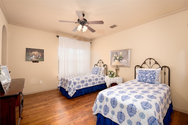 bedroom with hardwood / wood-style floors, ceiling fan, and ornamental molding