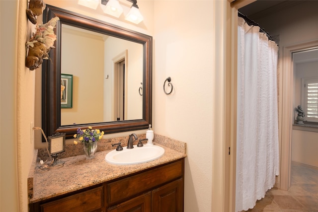 bathroom featuring tile patterned flooring and vanity