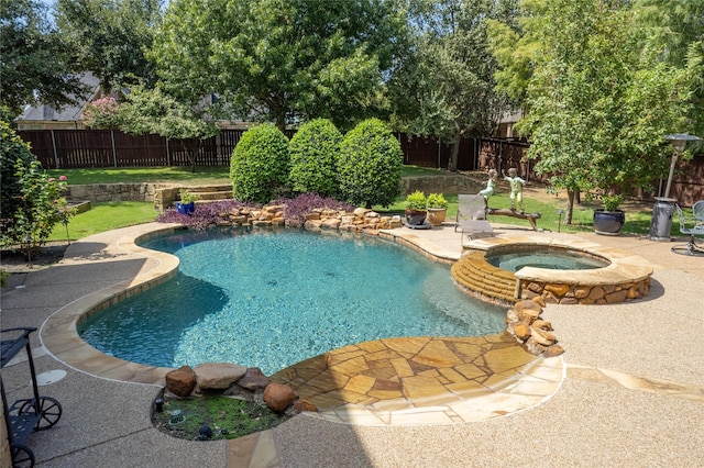 view of pool with a patio area and an in ground hot tub