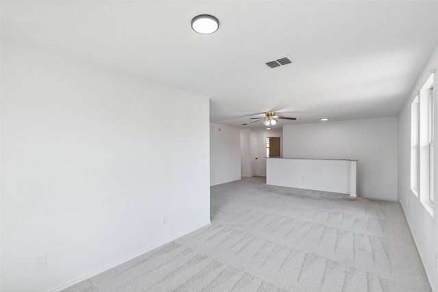 unfurnished room featuring ceiling fan and light colored carpet