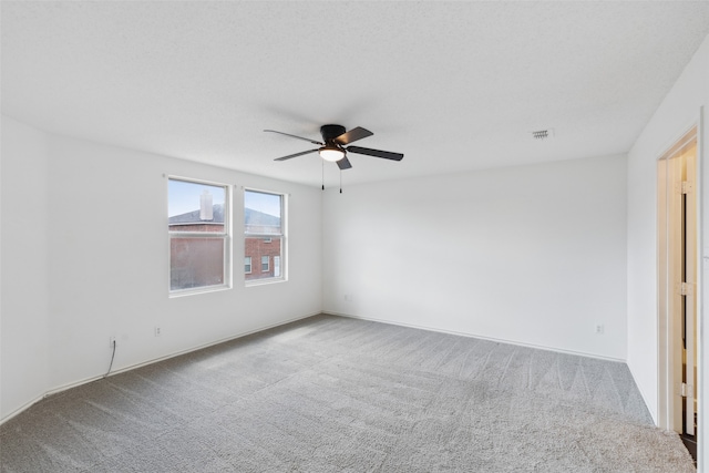 spare room with ceiling fan and light colored carpet