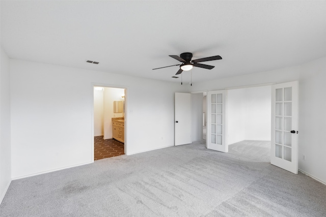 unfurnished room with carpet, ceiling fan, and french doors