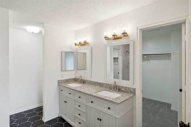 bathroom featuring a textured ceiling and vanity