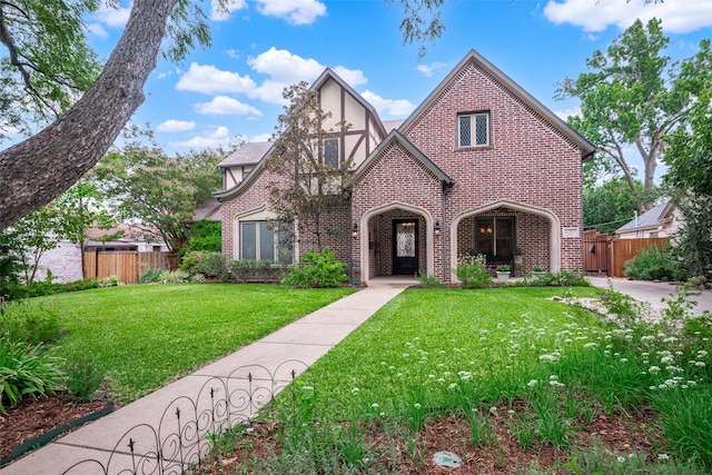 tudor home with a front lawn