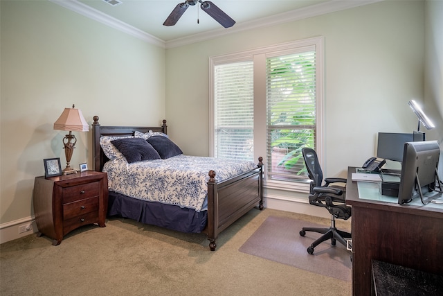 carpeted bedroom with ceiling fan, ornamental molding, and multiple windows