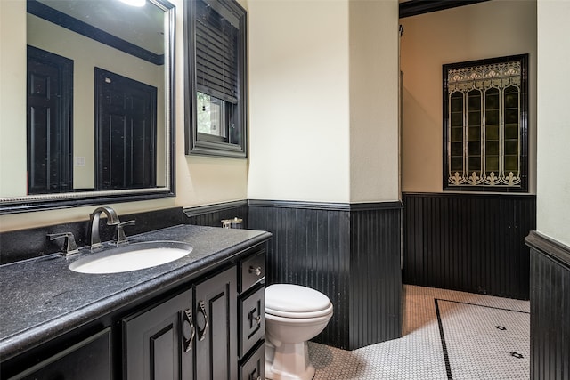 bathroom with vanity, toilet, and tile patterned flooring