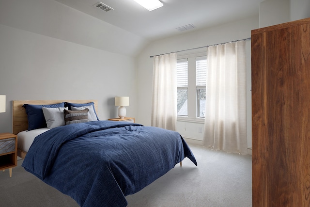 bedroom with vaulted ceiling and light carpet