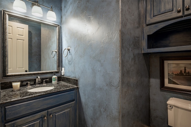 bathroom with toilet and vanity