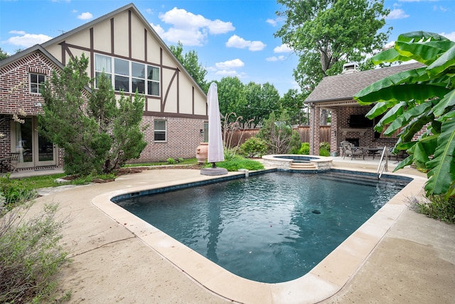 view of pool featuring an in ground hot tub and a patio area