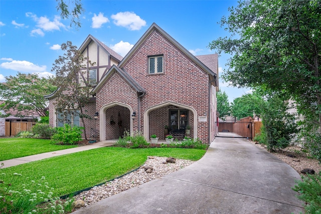 tudor house featuring a front yard