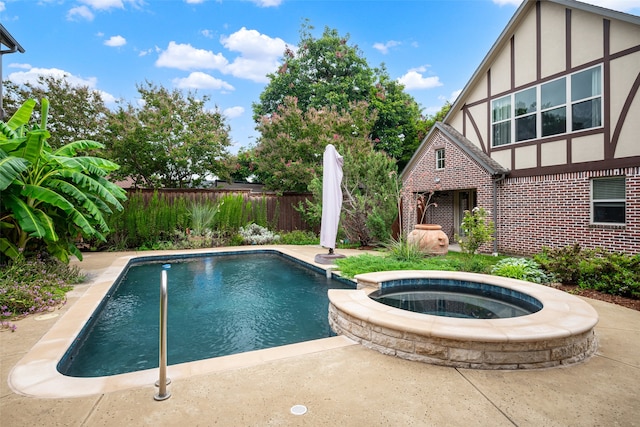 view of swimming pool with a patio and an in ground hot tub