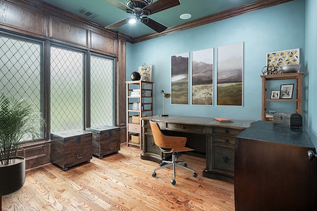 office space featuring ceiling fan, ornamental molding, and light hardwood / wood-style flooring