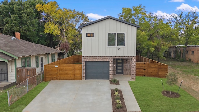 view of front of home with a front yard and a garage