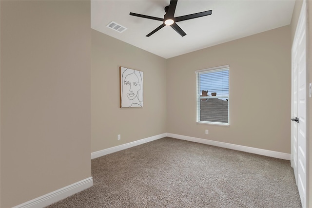 spare room featuring carpet floors, visible vents, baseboards, and a ceiling fan