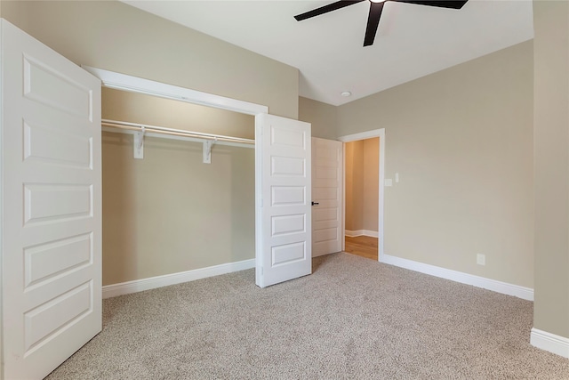 unfurnished bedroom with carpet floors, ceiling fan, baseboards, and a closet