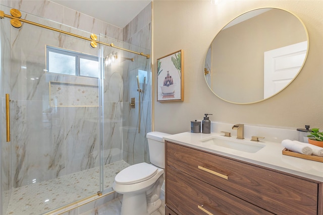 bathroom with toilet, a marble finish shower, and vanity