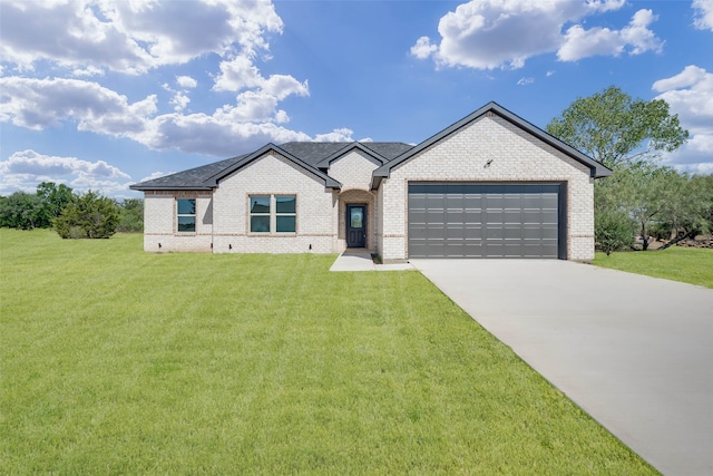 view of front facade with a front yard and a garage