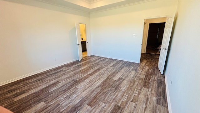 unfurnished room with crown molding and dark hardwood / wood-style flooring