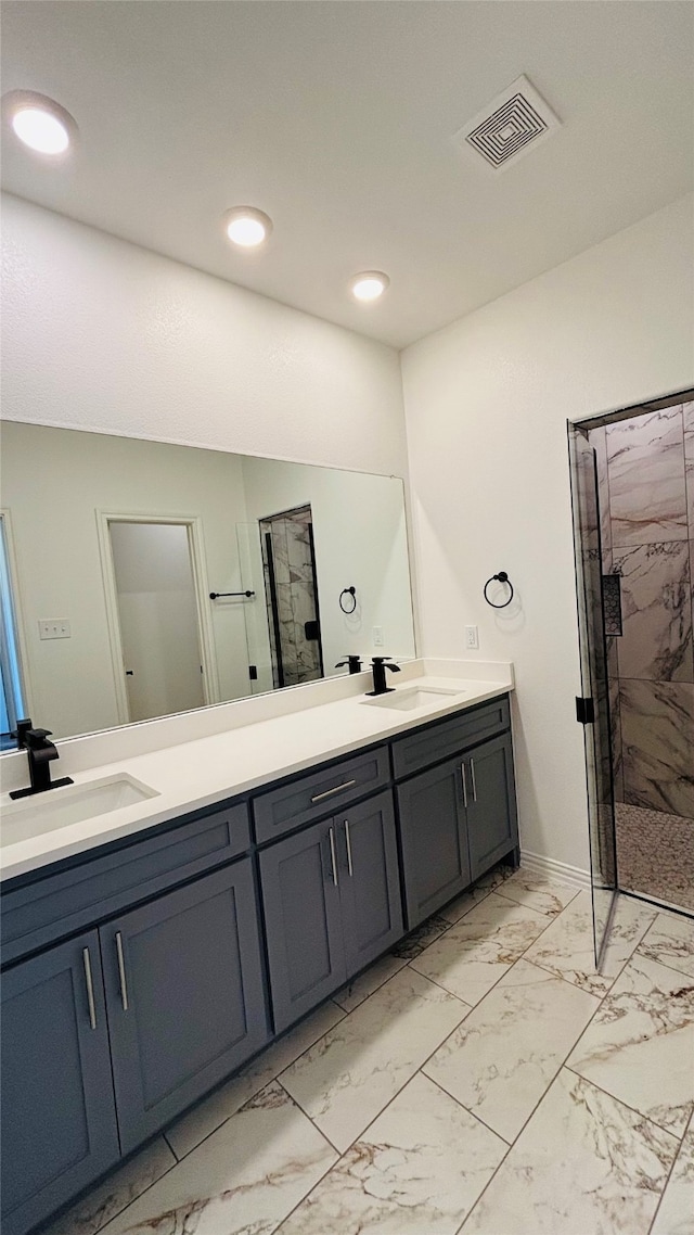 bathroom featuring a shower with door and vanity