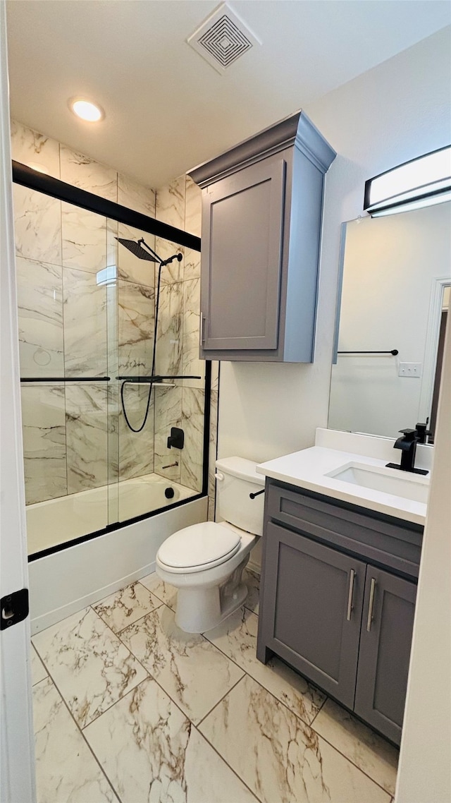 full bathroom with shower / bath combination with glass door, vanity, and toilet