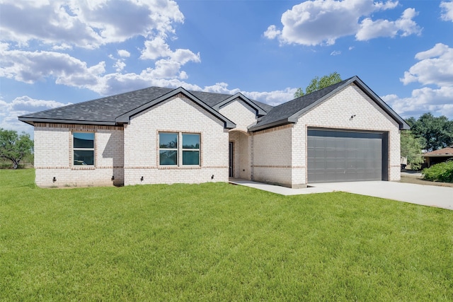 view of front of home with a front yard and a garage