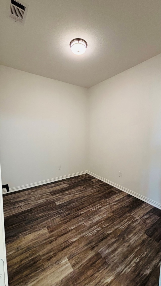 spare room featuring dark hardwood / wood-style flooring