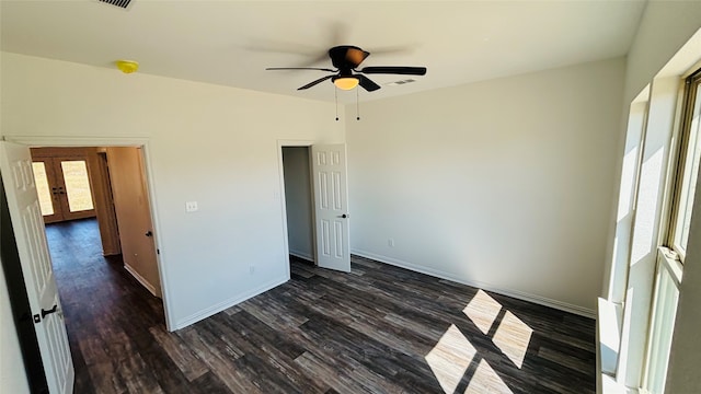 unfurnished bedroom with ceiling fan and dark hardwood / wood-style flooring