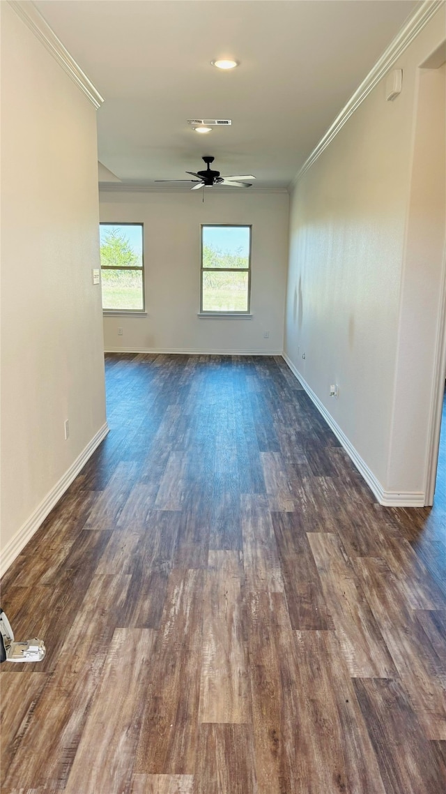 empty room with ceiling fan, ornamental molding, and dark hardwood / wood-style flooring