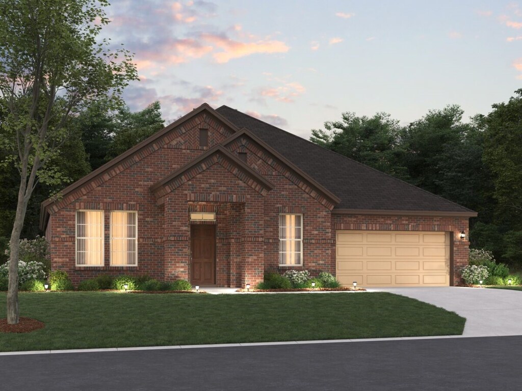 view of front of house featuring a garage and a yard