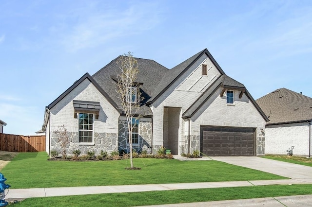 view of front of home with a front lawn and a garage