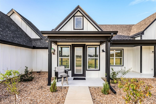 6770 Fm 1372nd Rd, North Zulch, TX 77872 - view of exterior entry with a porch, a shingled roof, and board and batten siding